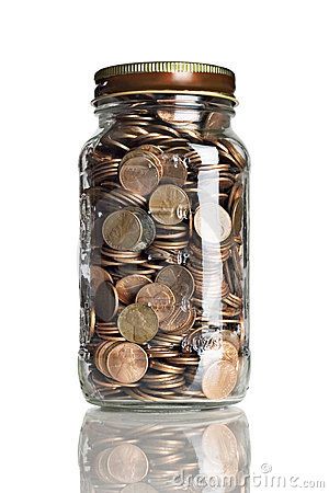 a glass jar filled with lots of coins