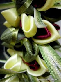 a bunch of ribbons that are on top of each other in the shape of flowers