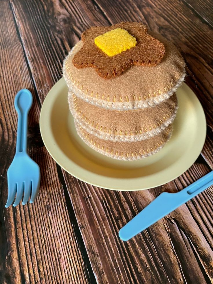 a stack of pancakes sitting on top of a plate next to a fork and knife