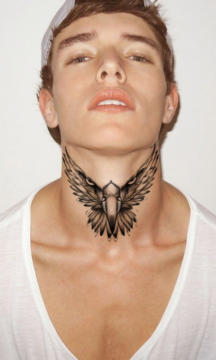 a man with a bird tattoo on his neck