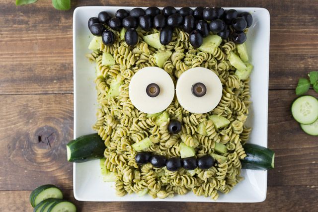 a plate with noodles and vegetables in the shape of a face