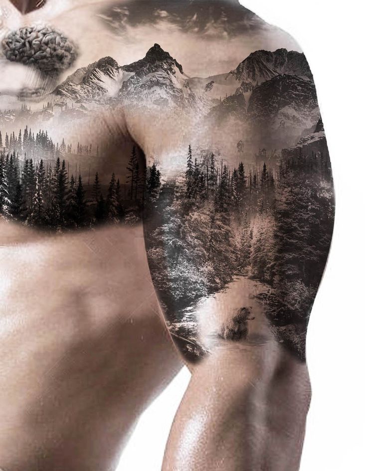 a man with tattoos on his body and trees in the mountains is shown from behind