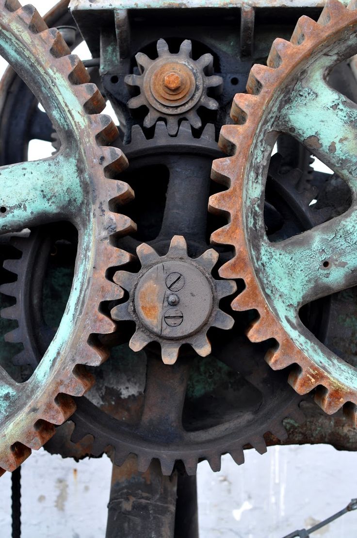 an old clock with gears attached to it