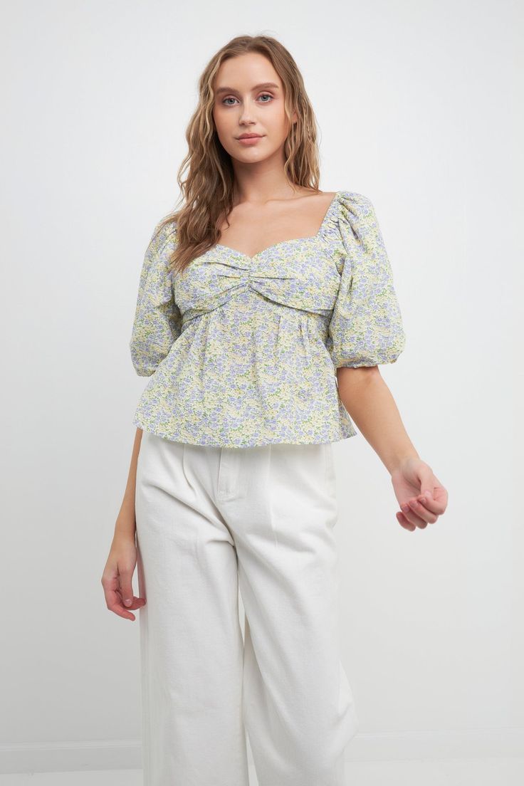 Elevate your everyday style with this pretty tie back top. Blooming with floral charm, this top is perfect for dressing up or down. The tie detail at the nape of the neck adds a touch of elegance, while the puff sleeves keep it feeling fun and flirty. Whether you're meeting friends for lunch or out on a date night, this top is sure to elevate your look. Floral print Tie detail at back Puff sleeves Sweet heart neckline Hand wash cold Do not bleach Do not tumble dry Iron low Shell: 100% Cotton Lin Fitted Puff Sleeve Top With Floral Print, Spring Tie-back Top With Tie Neck, Feminine Floral Print Puff Sleeve Top, Feminine Floral Print Long Sleeve Puff Top, Summer V-neck Puff Sleeve Top With Floral Print, Printed Ties, Tie Backs, Puff Sleeve, Short Sleeves Tops