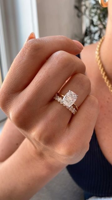 a woman wearing a diamond ring on her finger