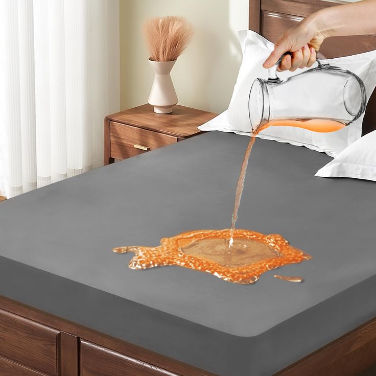 someone is pouring orange liquid on a bed