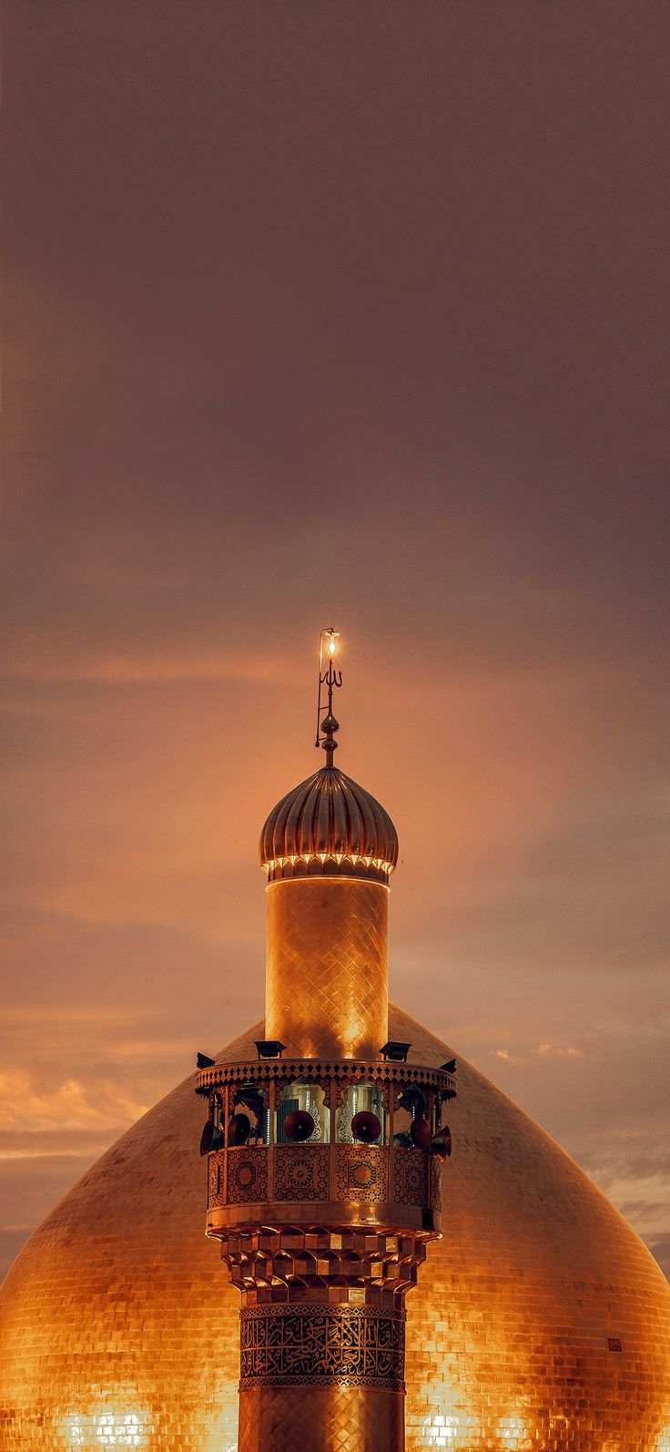 a large dome with a clock on the top and lights around it at night time