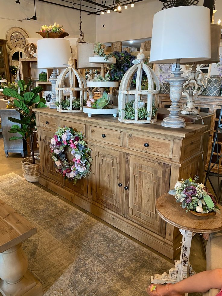 a room filled with lots of furniture and flowers on top of it's tables