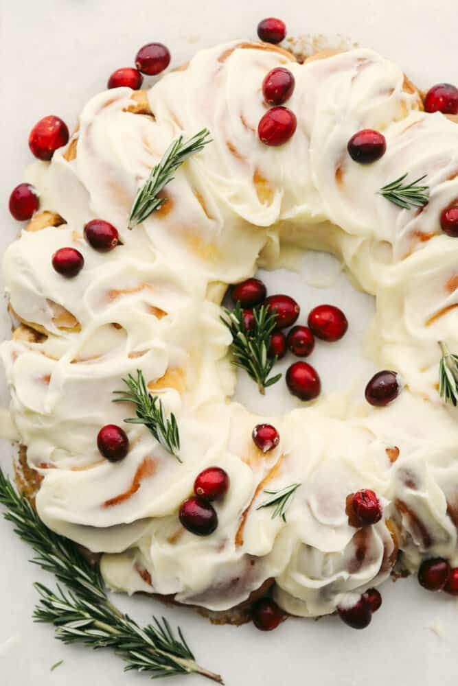 a cake with white frosting and pomegranates on top