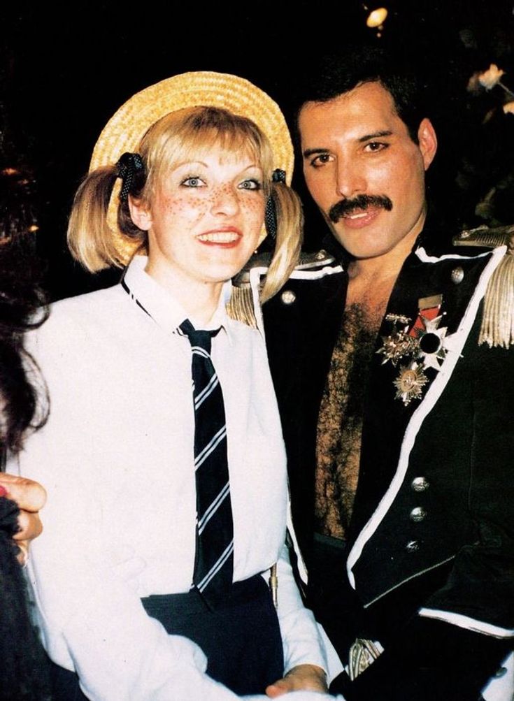 a man and woman dressed in costume posing for a photo