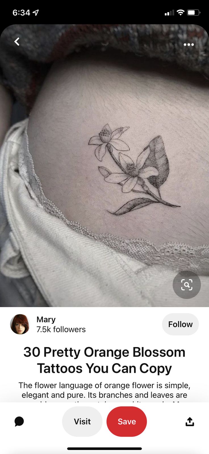 an orange blossom tattoo on the side of a woman's stomach, with text below it