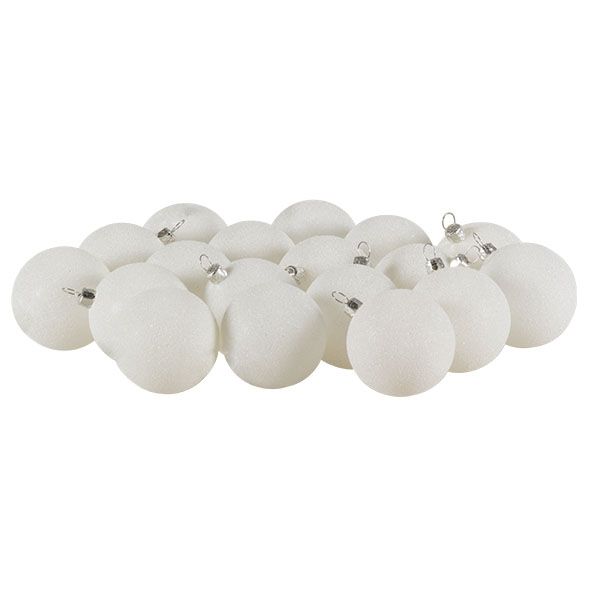 white christmas baubles are lined up on a white background