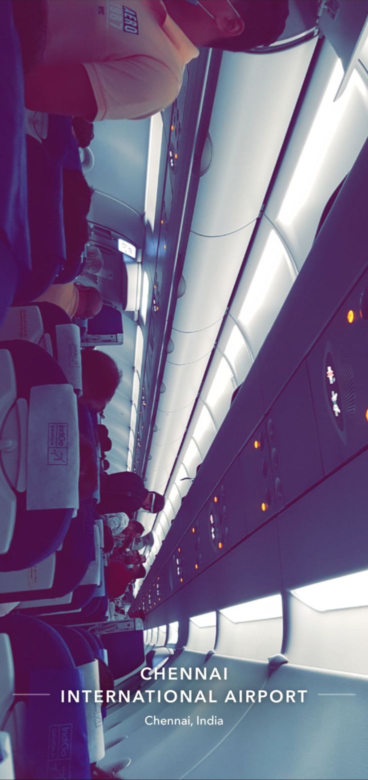 the inside of an airplane with people standing around