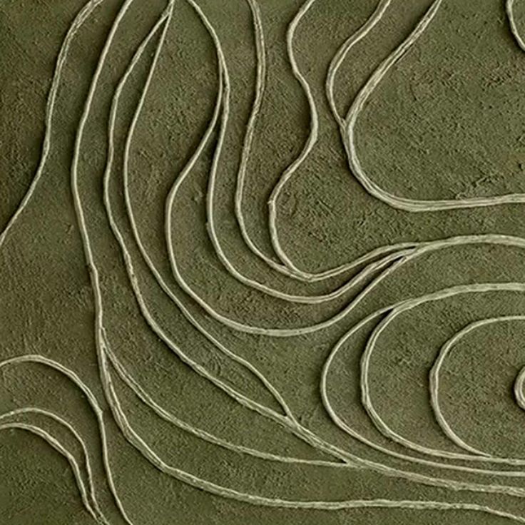 an abstract design made out of sand on the side of a beach with waves in it