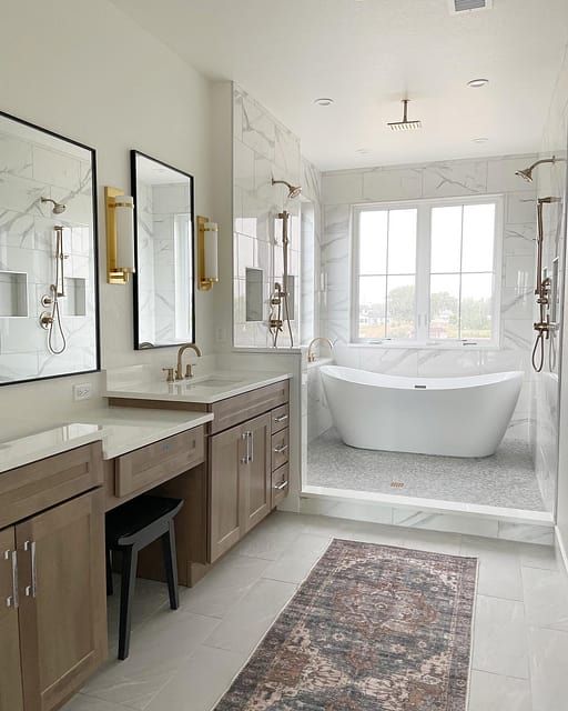 a large bathroom with two sinks and a bathtub in the middle of the room