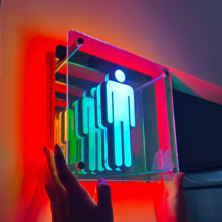 a person is holding up a colorful light box