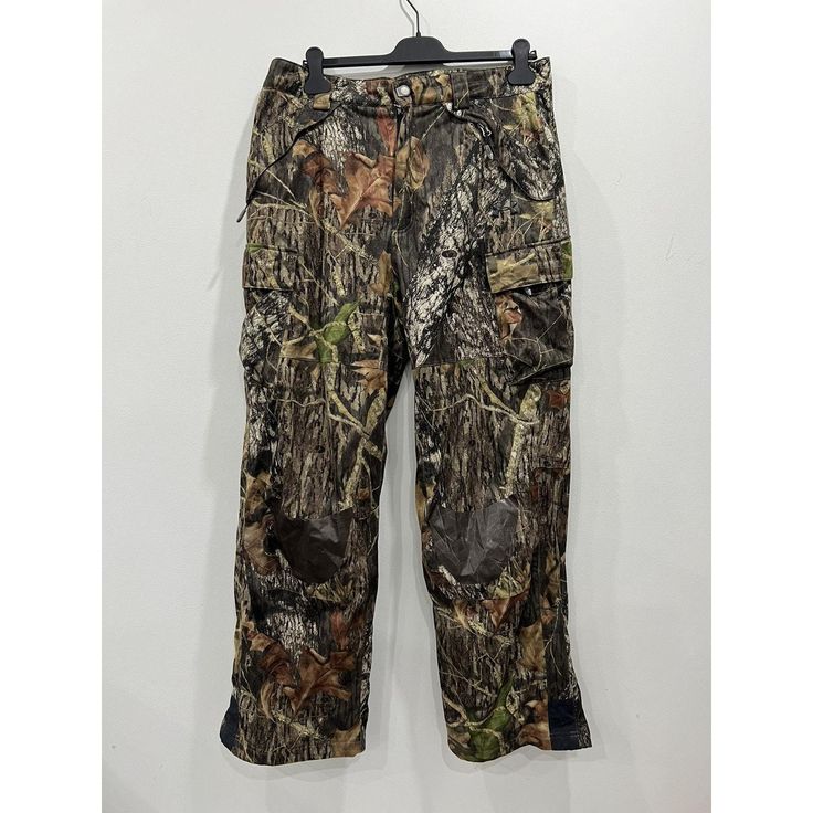 a pair of camouflage pants hanging on a hanger