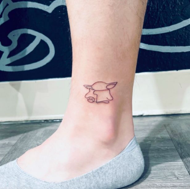 a small dog tattoo on the ankle