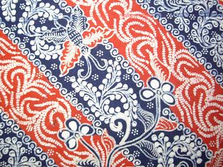 an orange, blue and white paisley print fabric