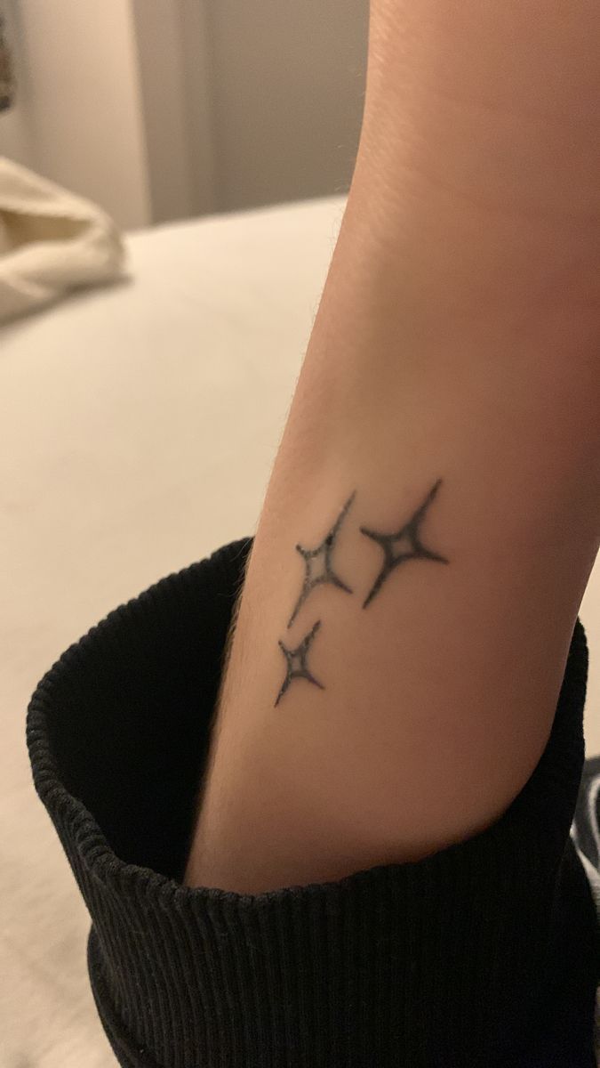 a woman's foot with three small stars on it