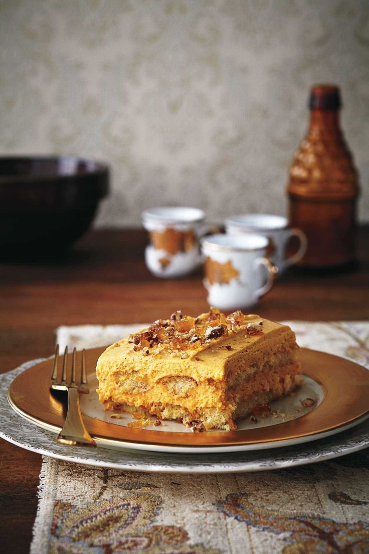 a piece of cake sitting on top of a plate next to a cup and saucer