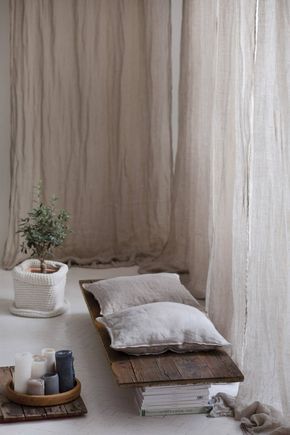 a bed sitting next to a window covered in curtains