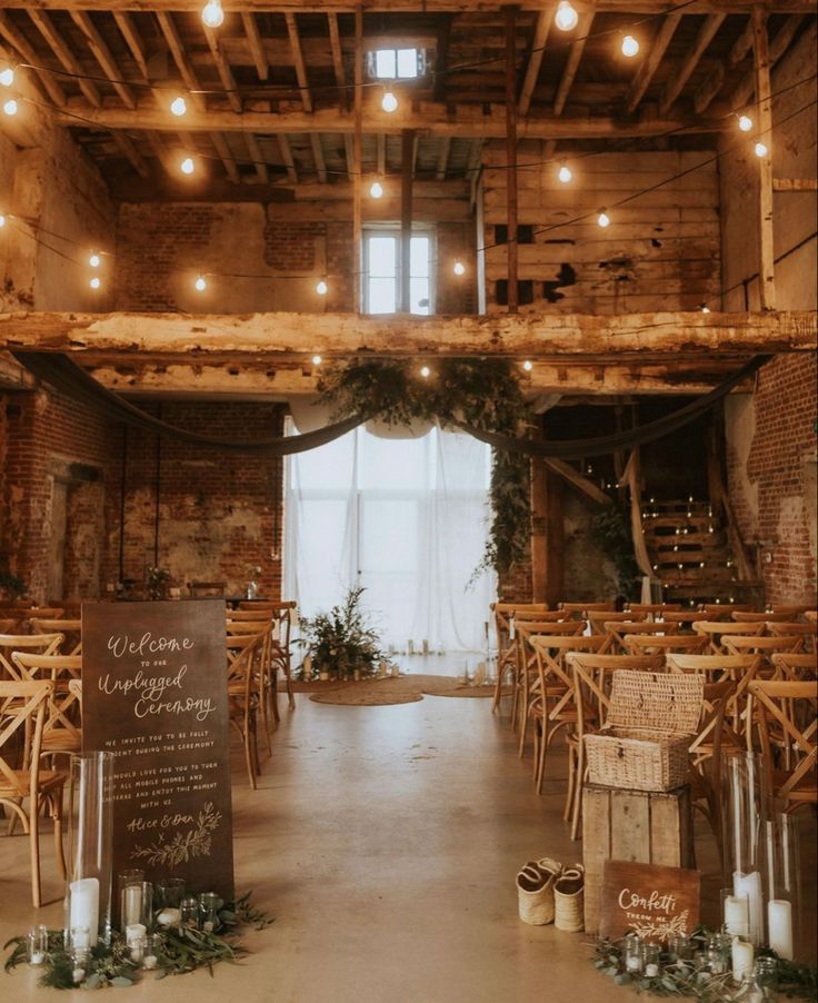 an indoor wedding venue with wooden tables and chairs