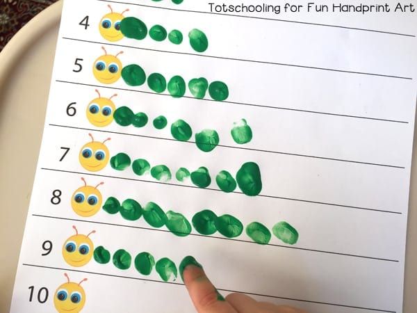 a child's hand is pointing at the number line on a sheet of paper