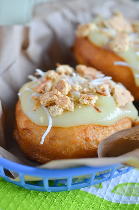 two pastries with toppings in a blue basket