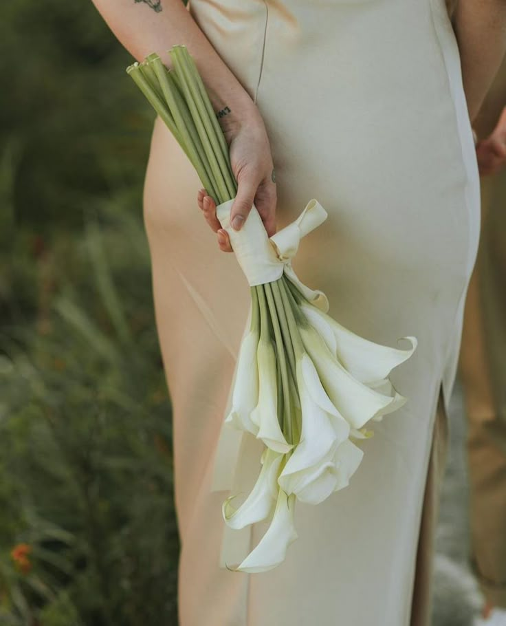 a person holding flowers in their hands