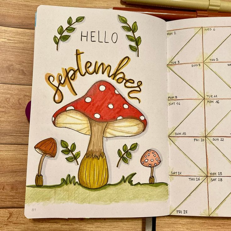 an open notebook with a drawing of a mushroom and the words hello september on it