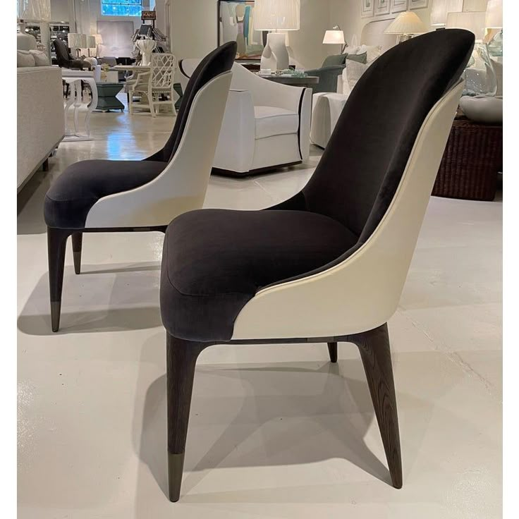 two chairs with black and white upholstered seats in a room filled with furniture