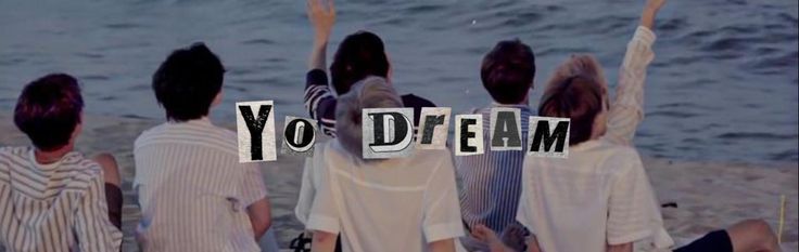 four people sitting on the beach with their arms in the air and letters spelling out yo d'eaam