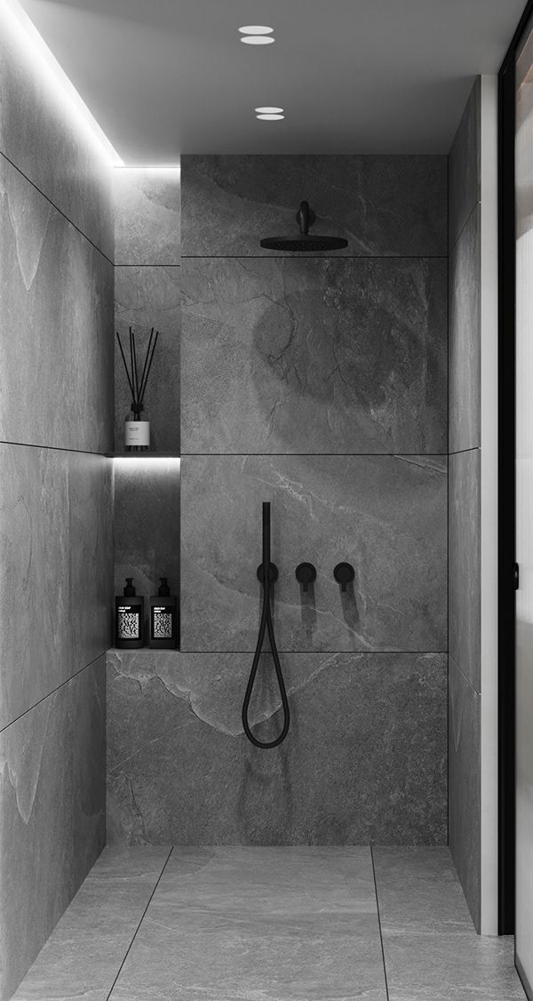 a black and white photo of a bathroom with marble walls, shelves and hooks on the wall