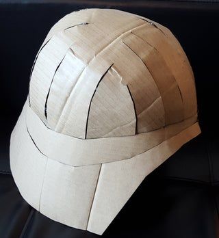 a helmet made out of cardboard sitting on top of a table