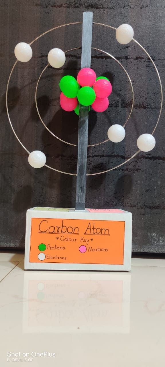 an object made out of plastic balls on top of a wooden stand with magnets attached to it