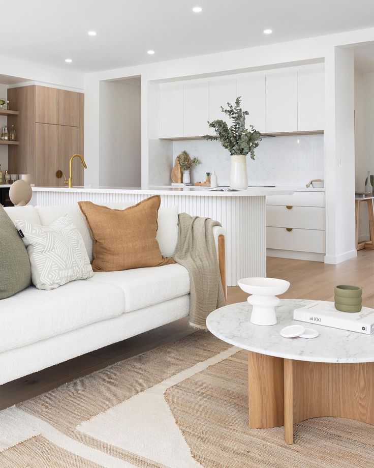 a living room filled with furniture and a white couch