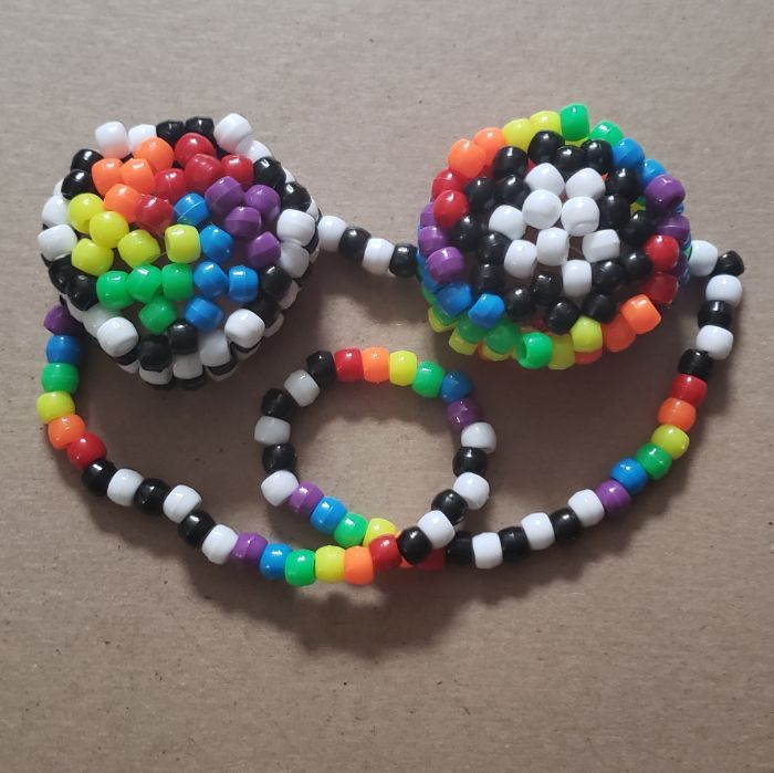 two multicolored beaded bracelets on a table