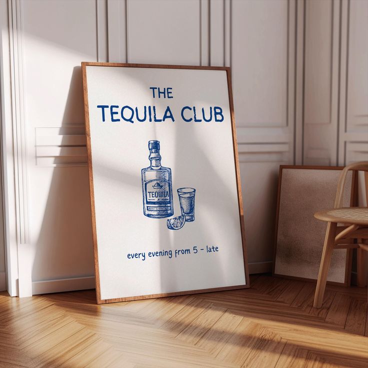 the tequila club sign is next to a chair and a table with a glass on it