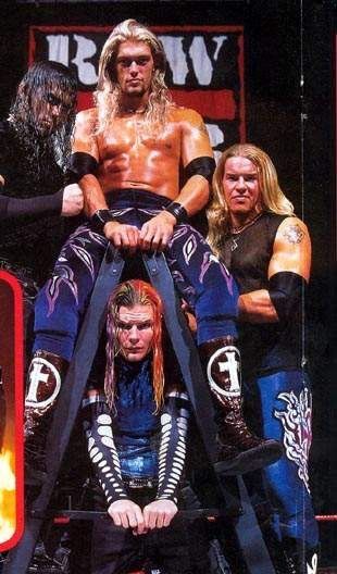 an image of a group of people in wrestling gear with one man on top of the other