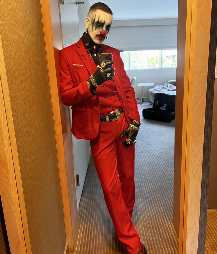 a man in a red suit and clown makeup