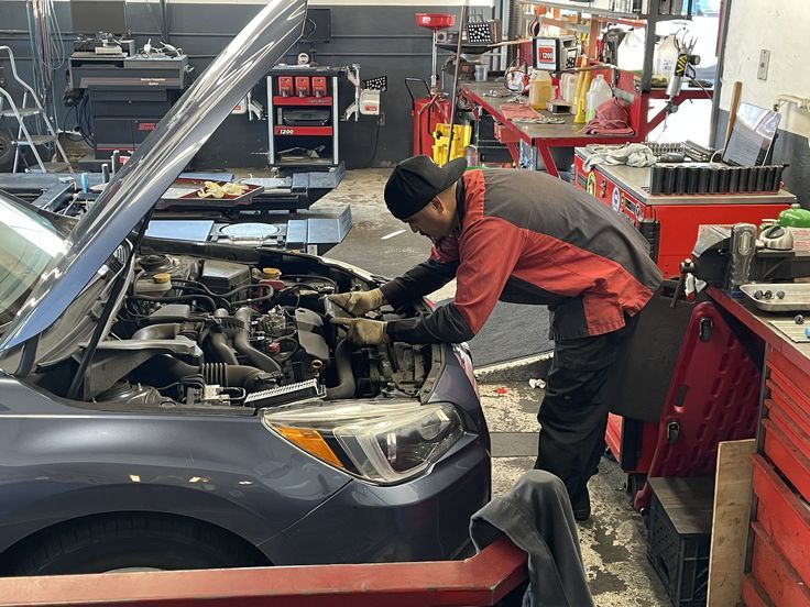 a man working on a car in a garage