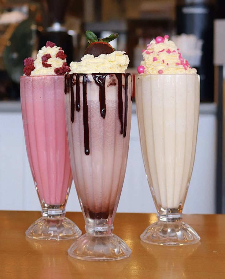 three different types of milkshakes on a table