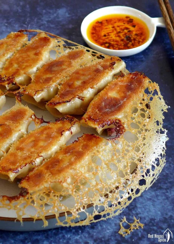 some food is sitting on a plate with dipping sauce