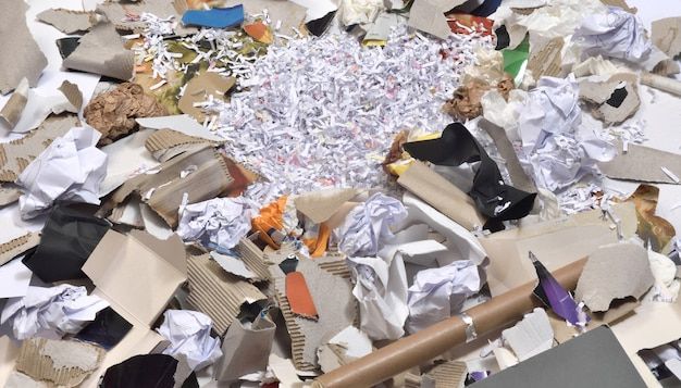 a pile of torn up papers sitting on top of a table