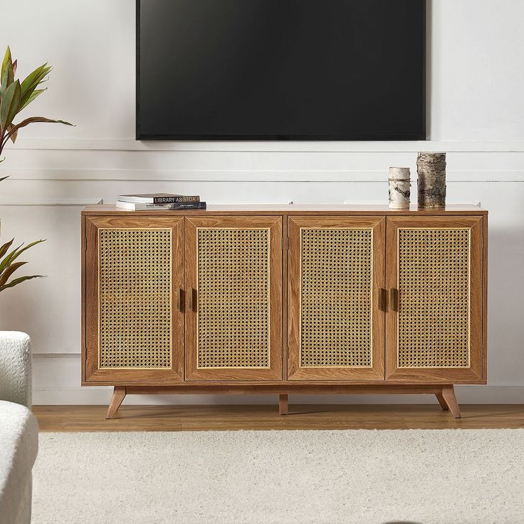 an entertainment center with wicker doors in front of a flat screen tv