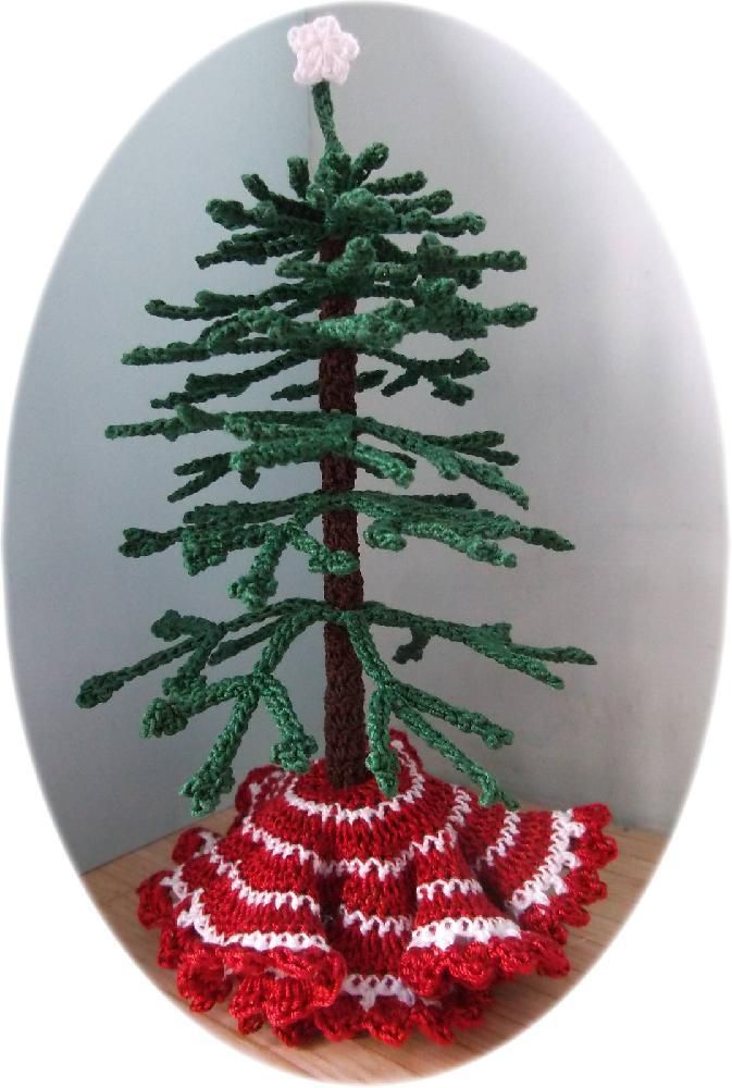 a crocheted christmas tree sitting on top of a wooden table