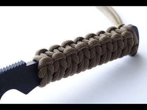 a close up of a knife with a rope on it