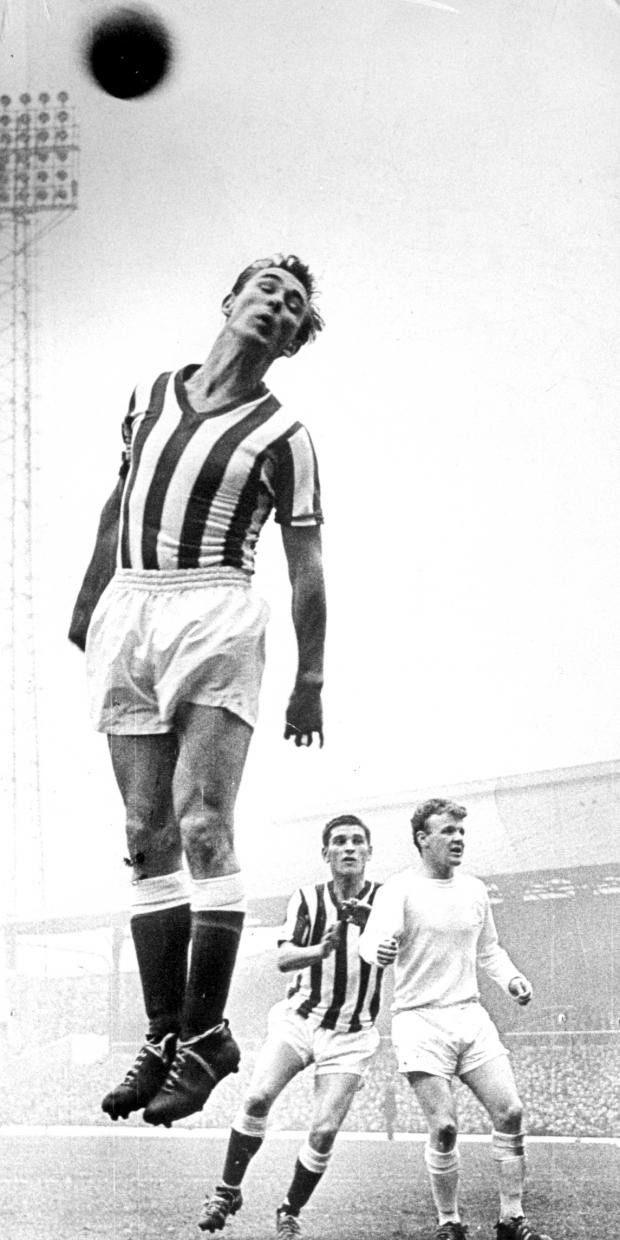 an old photo of two men playing soccer