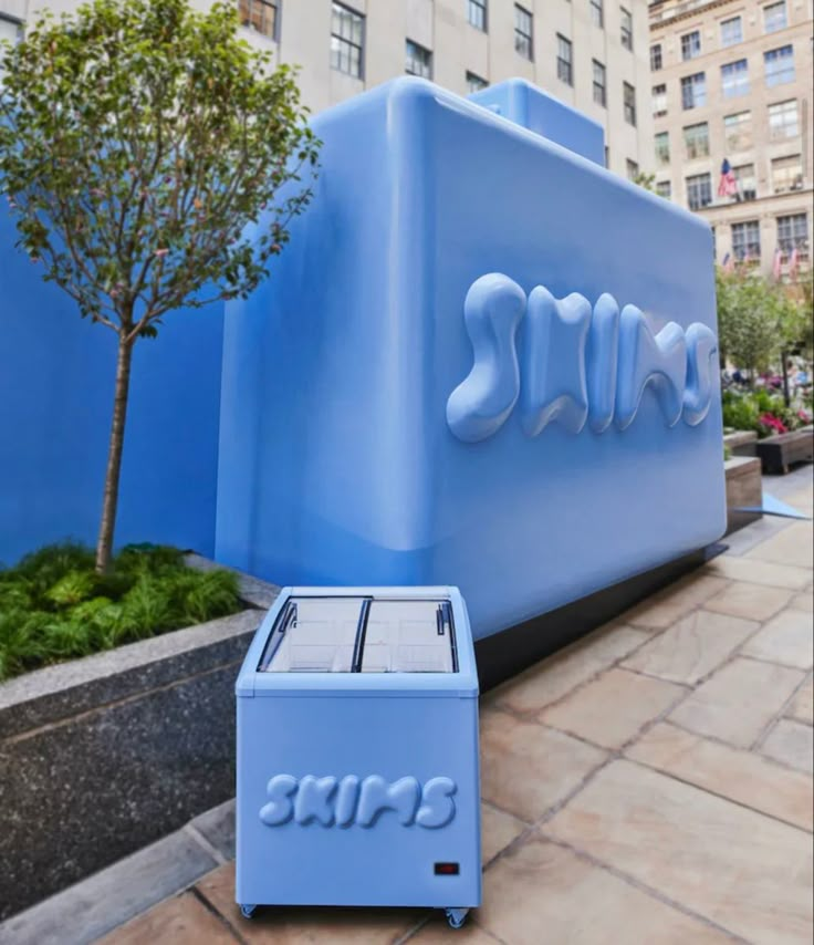 an icebox sits on the sidewalk in front of a giant sign that says skis